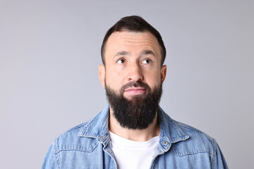 Obraz premium Man with mustache and beard on light grey background