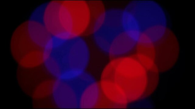 Abstract Defocused Police Emergency Lights Background. Blurred Red and Blue Bokeh Flashing at Night for News or Text Overlay.