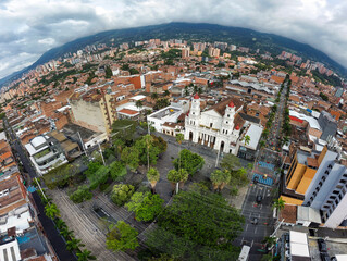 Fototapeta premium Envigado, Antioquia - Colombia. February 8, 2026. Panoramic drone view of the town's main church.