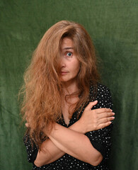 Woman with long hair on a green background,