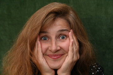 Woman with long hair on a green background,