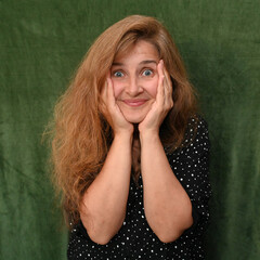 Woman with long hair on a green background,
