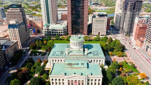 Aerial revealing shot of the Ohio State House and Columbus skyline with slow camera uplift in front of the Capitol