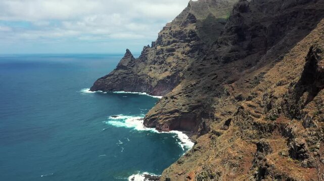 Aerial fly along Tenerife coastline approaching Baja de La Goleta rock formation over Atlantic ocean