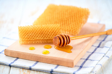 sweet honey with honeycomb on a white table.