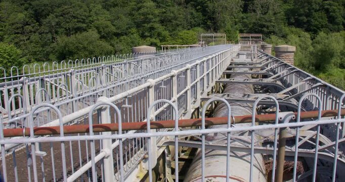 Wide shot looking across the top of Thirlmere aqueduct waterworks, showing the large water pipes.