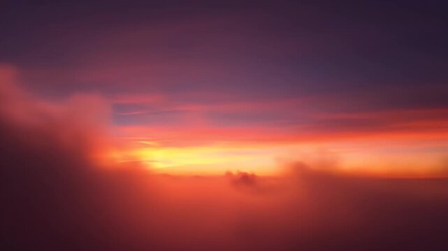 Fiery sunset with vibrant pink and orange clouds piercing through darkness