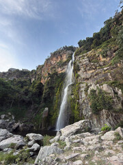 Wine Waterfall, Lara, Venezuela - Panoramic view of a natural mountain waterfall with a clear blue sky and rocky landscape