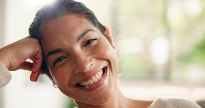 Happy, relax and face of woman on sofa for resting, calm and weekend break for wellness. Home, smile and portrait of person with laugh for me time, comfortable and chill on couch with positivity