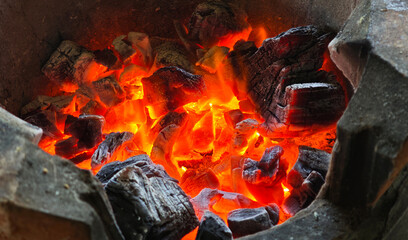 The charcoal in the stove is burning.