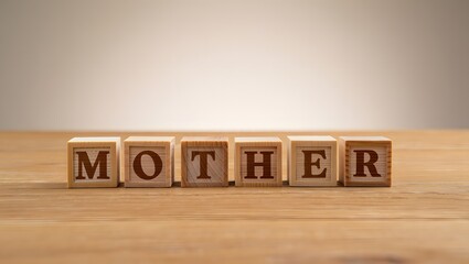 Wooden Blocks Spelling Out the Word Mother on a Wooden Surface