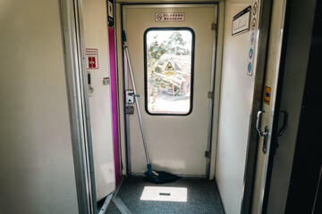 Train Door with Mop and No Smoking Sign