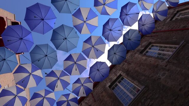 Colourful umbrellas in Old Quebec City. Tourist attractions of Quartier Petit Champlain lower town, shopping district and old French architecture