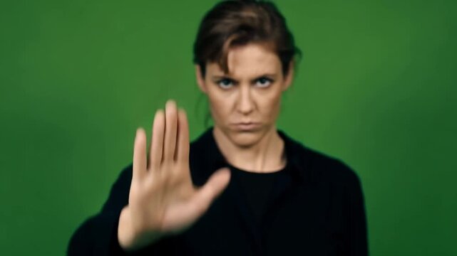 Serious Woman Gesturing Stop with Open Palm in Front of Green Screen Background Stock Video