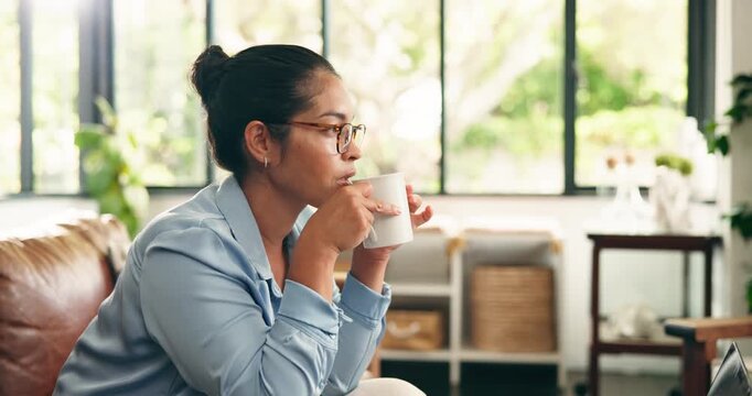 Serious, woman and thinking with coffee in home to start morning, inspiration and self reflection. Sofa, calm person and thoughtful with hot beverage in living room for planning day and contemplating