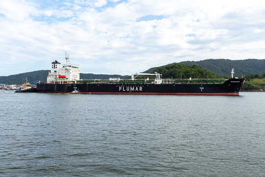 Santos, SP, Brazil - January 17 th, 2026: The oil tanker Flumar Brasil navigating the Santos Estuary with the assistance of a tugboat and a Sao Paulo Pilots speedboat.