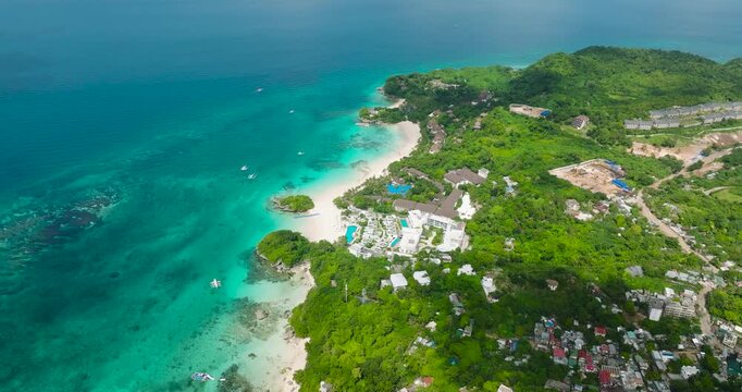 Aerial view of white sand and turquoise waters in Punta Bunga Beach. Hotels and Resorts in Boracay, Philippines.