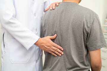 Physical therapy, Asian therapist doctor treat perform pain young man in hospital.