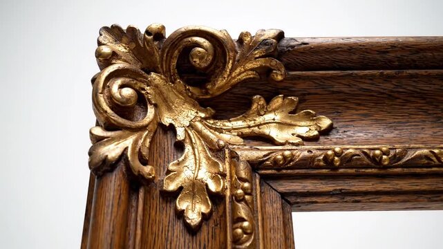Ornate antique wooden picture frame corner with gold leaf design