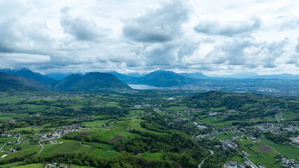 Fototapeta premium Aerial View of Aosta Valley with Highway, River and Alpine Mountains Under Stormy Sky