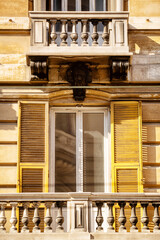 Building with timber shutters and small balcony
