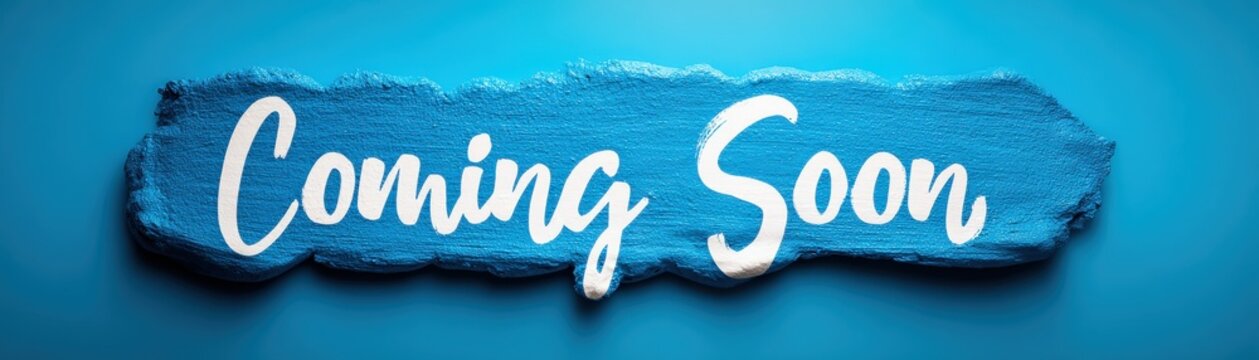 A blue paint stroke on a matching blue background with the white text "Coming Soon" written in a bold, cursive font.
