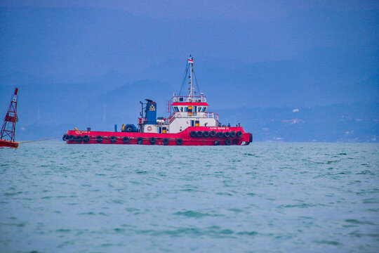 Palabuan Ratu - Sukabumi, West Java, Indonesia - December 21, 2021. Offshore tugboat sailing on rough ocean water