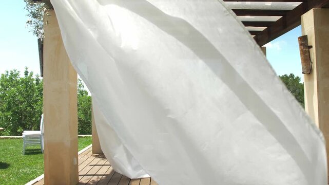White fabric moving in the wind on a Mediterranean finca in Mallorca