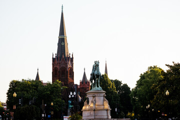Obraz premium Major General George Henry Thomas equestrian statue at Thomas Circle in Washington DC with historic church. g.