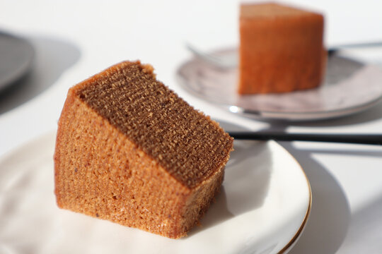 Chocolate baumkuchen slice on plate, minimal dessert concept