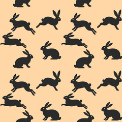 Seamless repeating pattern with black bunny rabbit silhouettes on a warm peach background. Modern Easter/spring surface pattern for textiles, wallpaper, wrapping paper and packaging.