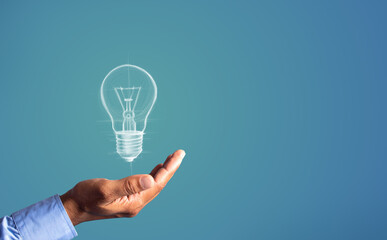 Hand Holding Sketch of Light Bulb Representing Idea, Creativity, and Innovation