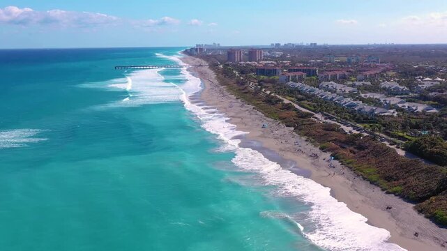 Aerial View of Juno Beach, Florida Coastal Scenery with Turquoise Ocean Waves Crashing on Sandy Shore