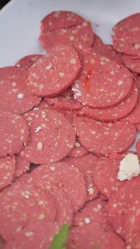 Close-up of Sliced Sucuk Sausage on a White Plate