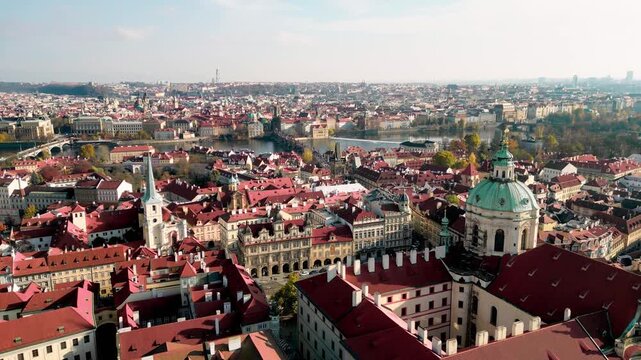 Vertical Drone Descent Over Prague with Saint Nicholas Church and Charles Bridge
