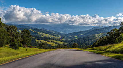 Fototapeta premium Scenic Valley Road with Rolling Green Hills and Clouds