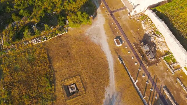 Gelemis, Turkey. Ancient Theatre of Patara integrated into Kursunlu Hill, man-made structure and natural landscape in morning. Aerial View, MasterShots, Tilt up, Zoom In