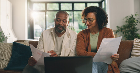 Discussion, document or couple with laptop on sofa, budget planning or track expenses for savings....