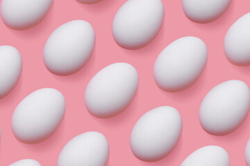 Natural white chicken eggs with soft shadow as minimal style pattern on pink background. Top view still life photo, creative food layout, egg day holiday concept, graphic flat lay pastel colored.