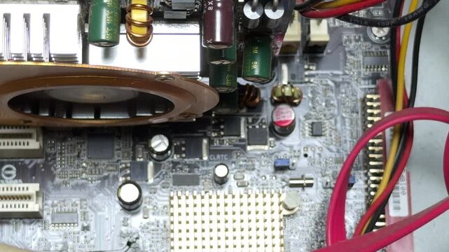 The complex motherboard circuits process data rapidly. This electrical activity generates a faint, high-pitched whining sound. A steady electronic buzz resonates from the active components.