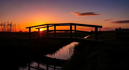 Fototapeta premium silhouette of bridge over water at sunset.