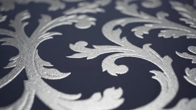 Intricate silver ornamental pattern on a dark blue background, offering a textured, slightly blurred aesthetic