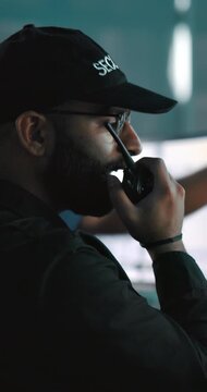 Surveillance, man or security guard with radio in control room, report observation or threat detection. Emergency, tech or crime prevention officer with safety monitoring, contact or info for danger