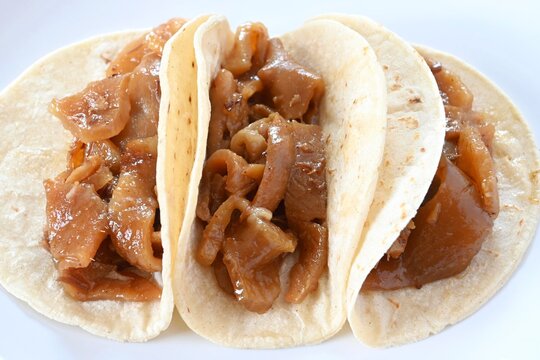 Traditional plain pork skin tacos (tacos de cueritos "sin nada"), ready to eat on corn tortillas.