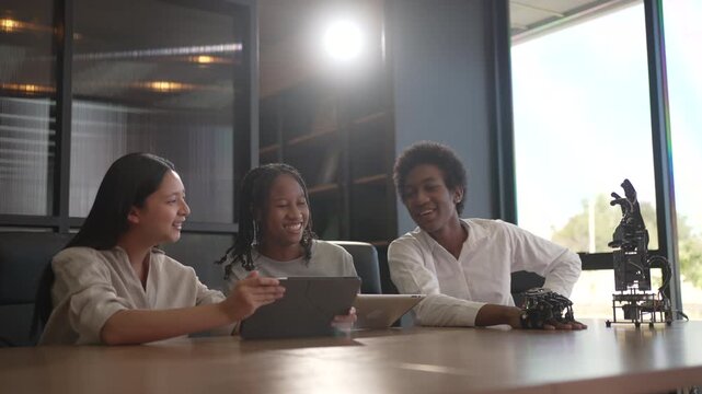 Group of students are brainstorming and working with robot arm at the science workshop. Education, technology, STEM