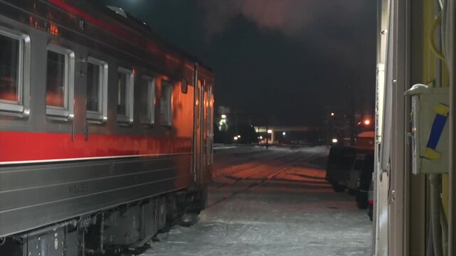 Illuminated Vending Machine on a Snowy Train Station Platform at Night in Furano, Hokkaido
