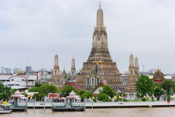 Naklejka premium Bangkok, Thailand - June 11, 2025: Pagoda at Wat Arun, or Wat Arun Ratchawararam, is a tourist landmark near the Chao Phraya River in Bangkok,Thailand.