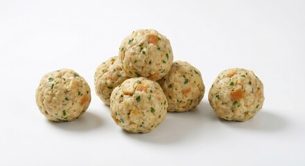 Obraz premium A pile of semmelknödel, austrian bread dumplings with herbs and vegetables on a white background