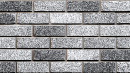 Obraz premium Brick wall with a gray and white color. The wall is made of bricks and has a rough texture