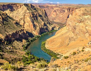 Fototapeta premium Vast canyon vista with a winding river and steep rock formations
